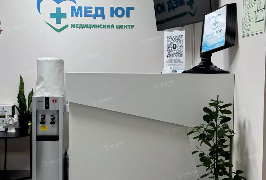 Место администратора клиники Мед Юг со стойкой,  телевизором и кулером